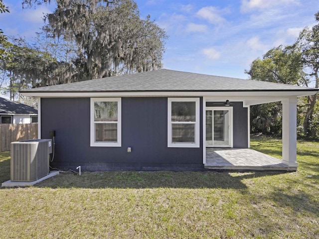 rear view of house featuring ceiling fan, a yard, a patio area, and central air condition unit