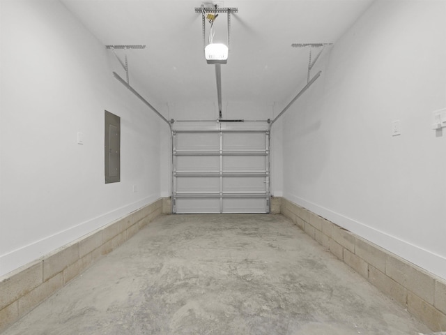 garage with a garage door opener and electric panel