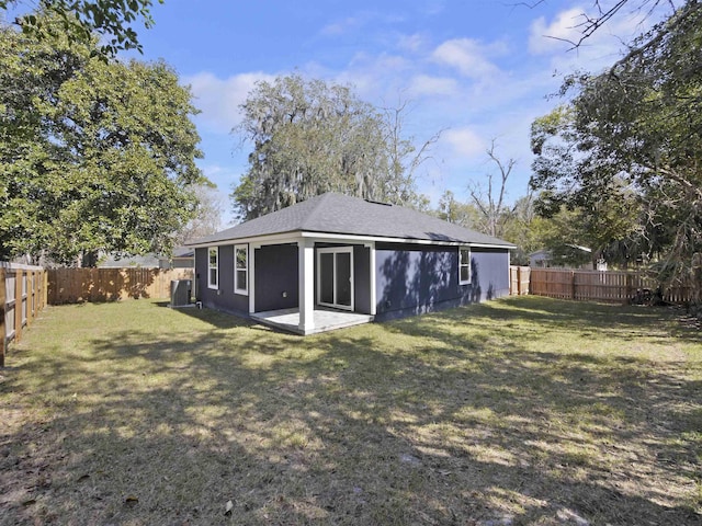 rear view of property with a yard and a patio area