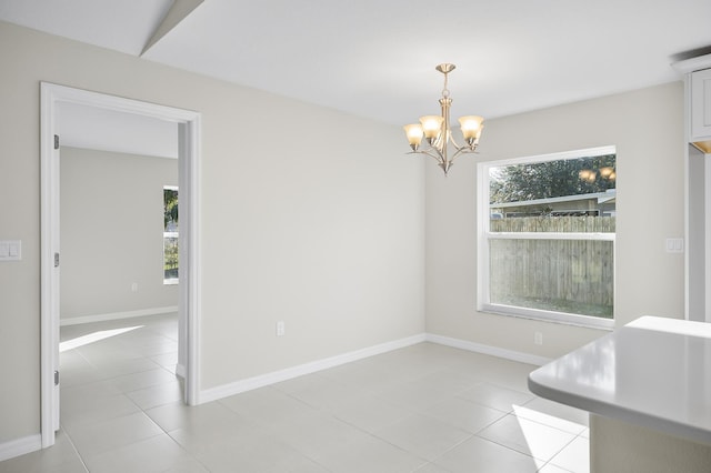 dining space with light tile patterned floors and a notable chandelier