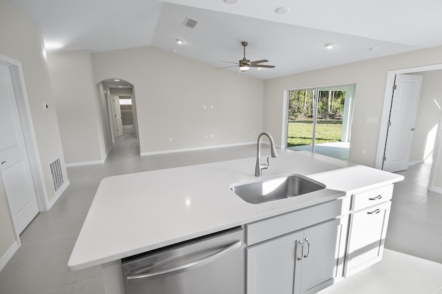 kitchen with lofted ceiling, sink, dishwasher, white cabinetry, and a center island with sink