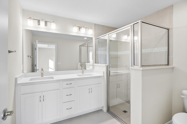 bathroom featuring an enclosed shower, vanity, tile patterned flooring, and toilet