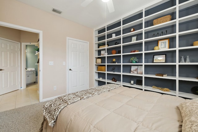 tiled bedroom featuring carpet floors, visible vents, and baseboards