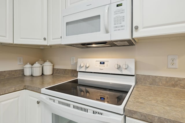 kitchen featuring white appliances and white cabinetry