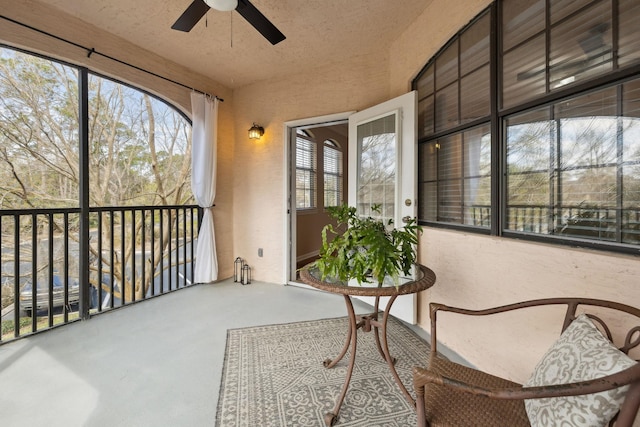 sunroom featuring ceiling fan