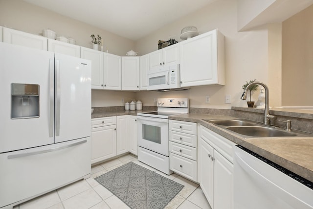 kitchen with white appliances, light tile patterned floors, white cabinetry, and a sink