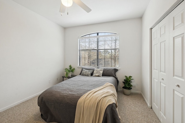 bedroom with a ceiling fan, a closet, carpet flooring, and baseboards