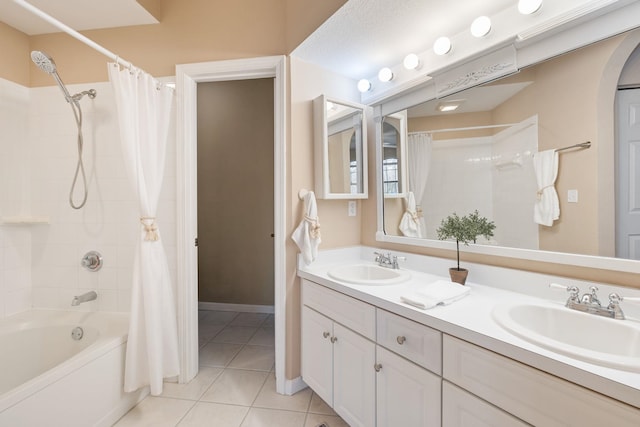 full bathroom featuring shower / tub combo, double vanity, a sink, and tile patterned floors