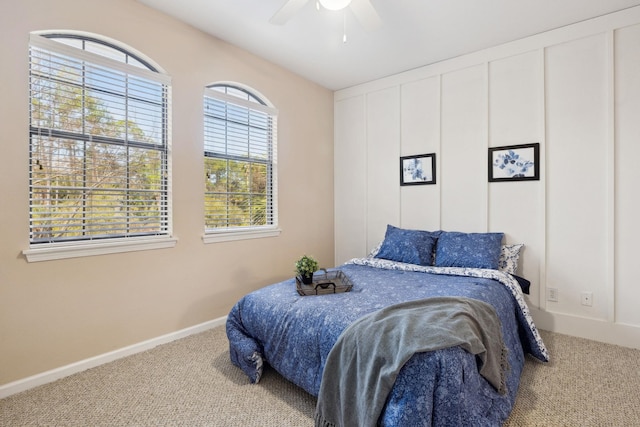 bedroom with ceiling fan, baseboards, and carpet flooring