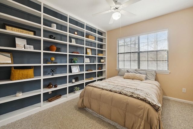 carpeted bedroom with a ceiling fan and baseboards