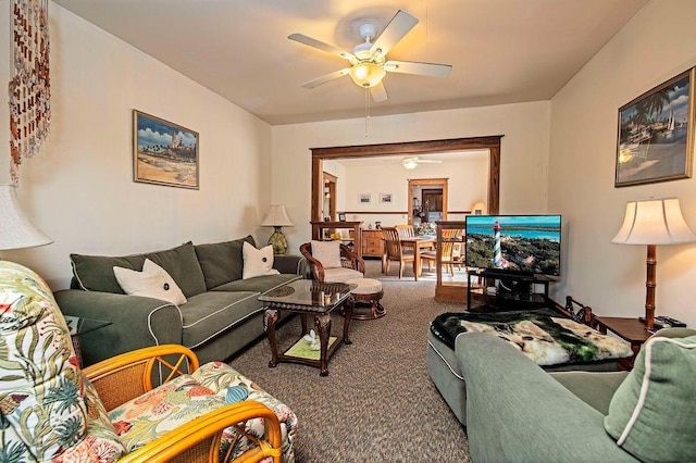 carpeted living room with ceiling fan