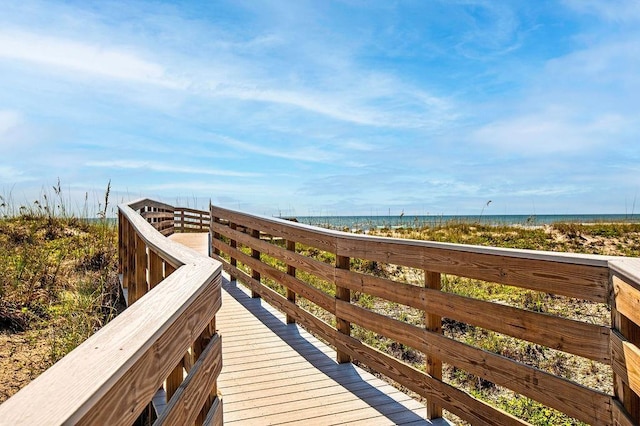 view of property's community with a beach view and a water view