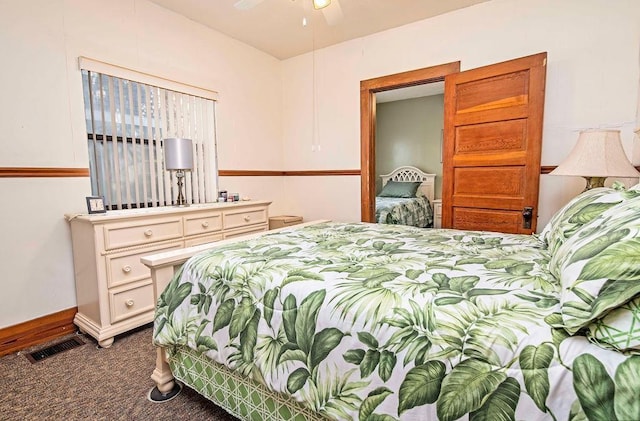 bedroom with ceiling fan and dark carpet