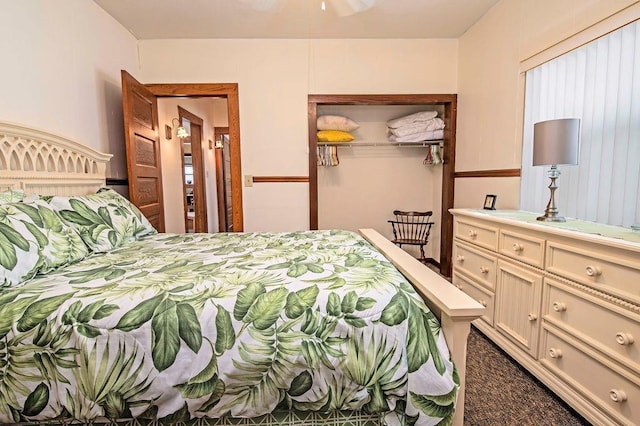 bedroom with dark colored carpet and a closet