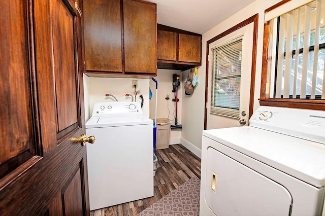 clothes washing area featuring cabinets, dark hardwood / wood-style floors, and separate washer and dryer