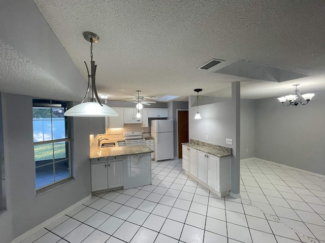 kitchen with white cabinets, pendant lighting, white appliances, and a textured ceiling