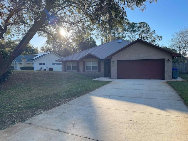 single story home featuring a front yard and a garage