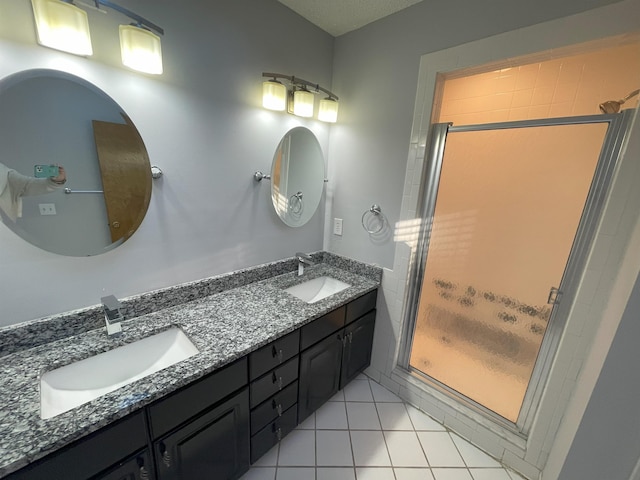 bathroom with vanity, tile patterned floors, and a shower with door