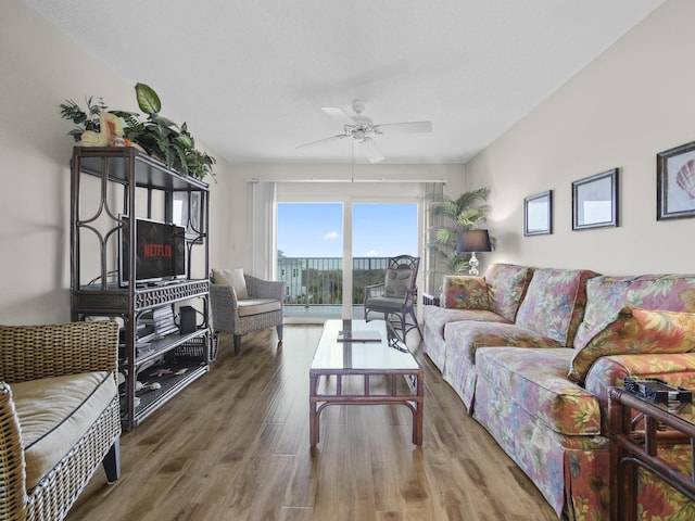 living room featuring wood finished floors and ceiling fan