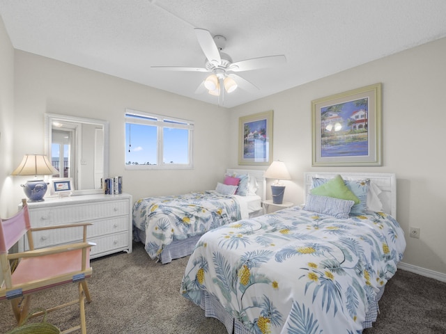 carpeted bedroom featuring baseboards and a ceiling fan