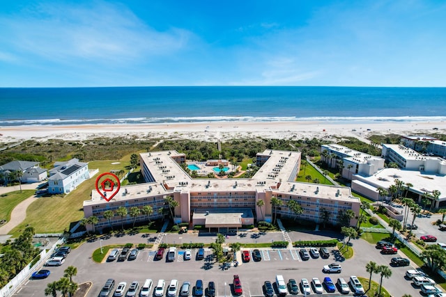 birds eye view of property featuring a beach view and a water view