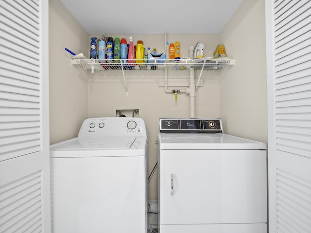 laundry area with washing machine and clothes dryer and laundry area