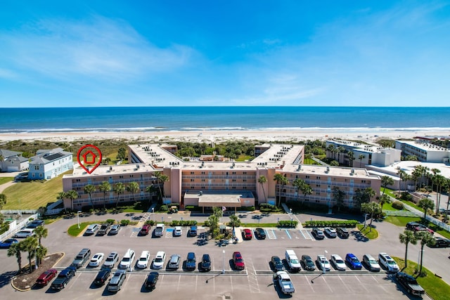 drone / aerial view with a water view and a view of the beach