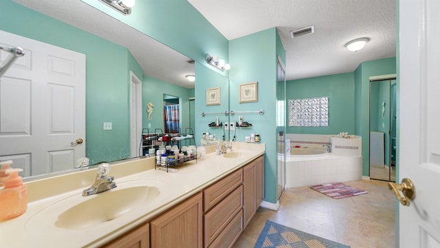 bathroom with tile patterned flooring, vanity, a textured ceiling, and shower with separate bathtub