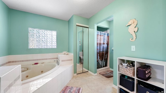 bathroom with tile patterned floors, toilet, a textured ceiling, and independent shower and bath