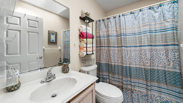 bathroom featuring a shower with curtain, vanity, toilet, and a skylight