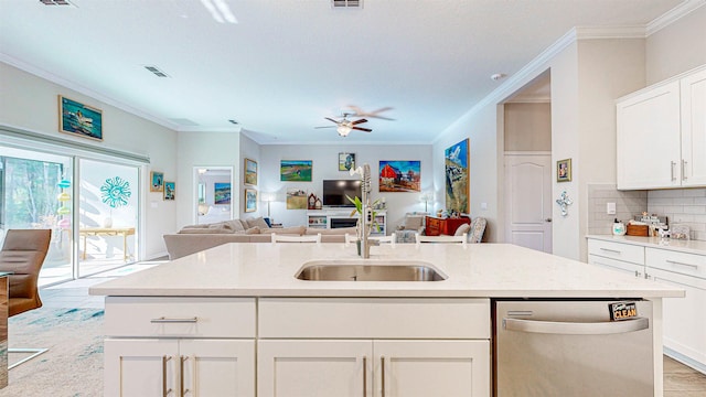 kitchen featuring sink, crown molding, dishwasher, white cabinets, and decorative backsplash