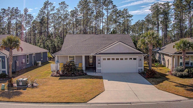 view of front of home with a garage and a front lawn