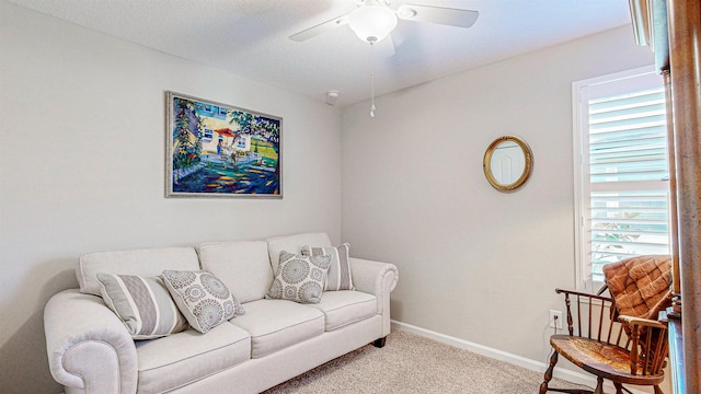 living room with ceiling fan, light colored carpet, and a textured ceiling