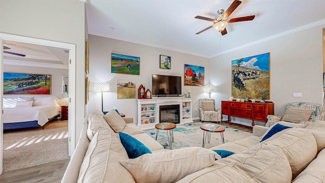 living room with crown molding, light wood-type flooring, and ceiling fan