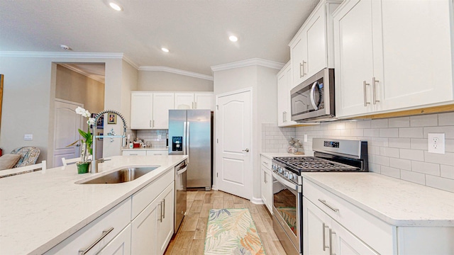 kitchen featuring white cabinetry, stainless steel appliances, and light wood-type flooring