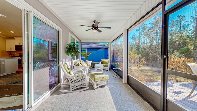 sunroom / solarium featuring ceiling fan