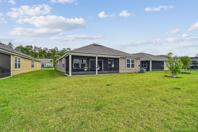 100 Dove Tree Ln, Saint Augustine, FL 32095 - rear view of house with a sunroom, a yard, and roof with shingles