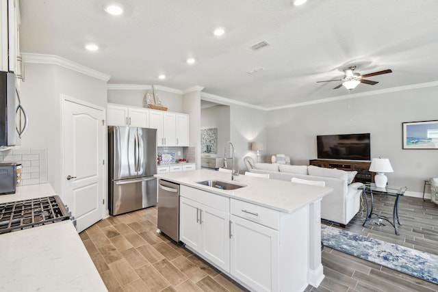 100 Dove Tree Ln, Saint Augustine, FL 32095 - kitchen with stainless steel appliances, tasteful backsplash, a ceiling fan, open floor plan, and white cabinetry