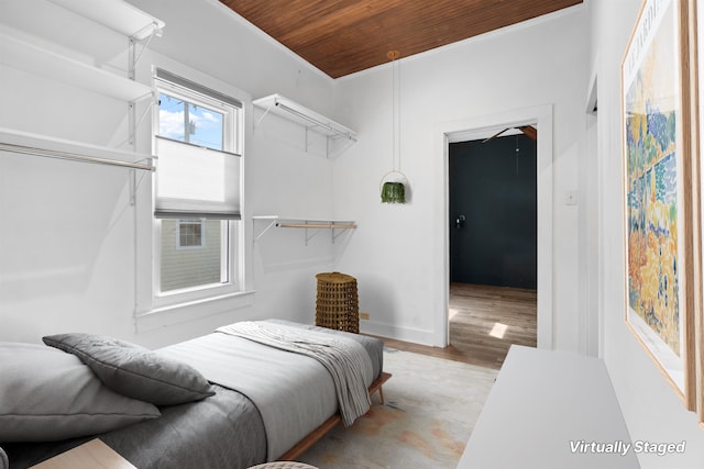 bedroom with wooden ceiling and wood finished floors