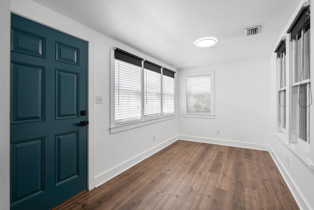 entrance foyer featuring dark wood-style floors, baseboards, and visible vents