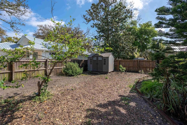 view of yard featuring a fenced backyard, an outdoor structure, and a storage unit