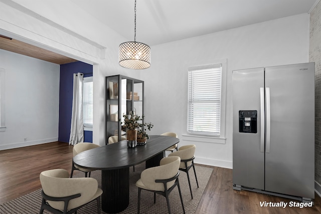 dining room with baseboards and dark wood-type flooring