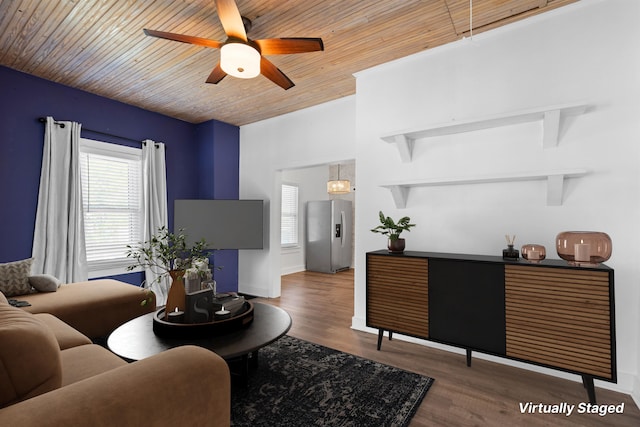 living room featuring ceiling fan, baseboards, a healthy amount of sunlight, and wood finished floors