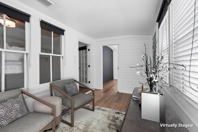 interior space with wood finished floors and visible vents