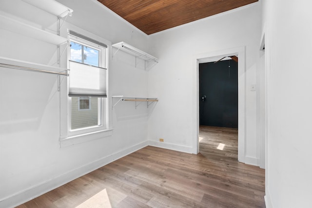walk in closet with wood finished floors