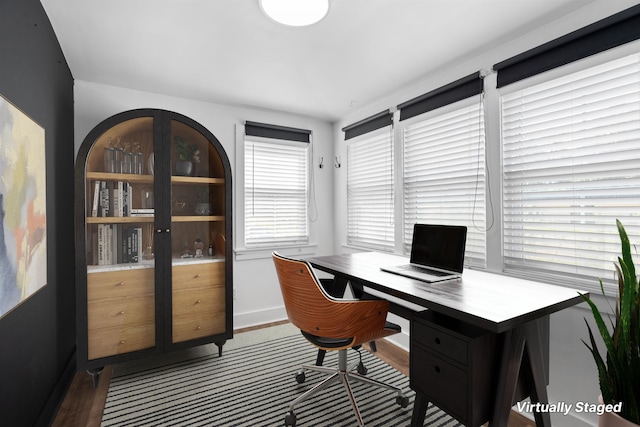 home office featuring wood finished floors and baseboards