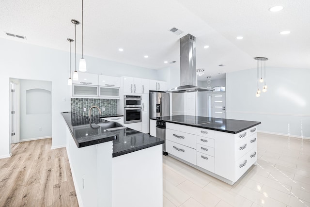 kitchen with white cabinetry, hanging light fixtures, tasteful backsplash, extractor fan, and appliances with stainless steel finishes