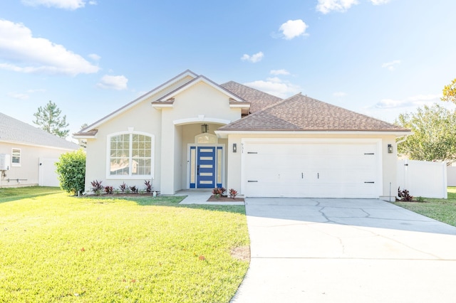 single story home with a front yard and a garage