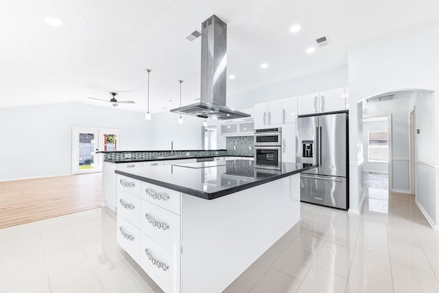 kitchen with island exhaust hood, white cabinetry, a healthy amount of sunlight, and appliances with stainless steel finishes