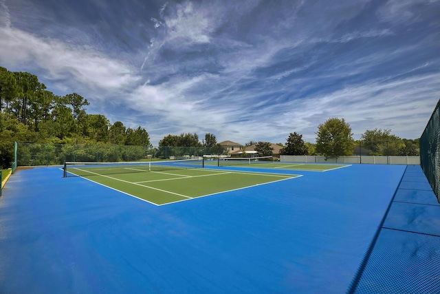 view of tennis court with basketball hoop